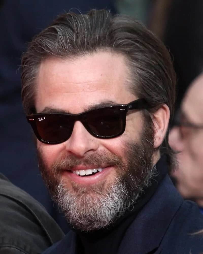 Chris Pine went with a scruffy salt and pepper look with a slicked back long hair at the Jeff Bridges Hand and Foot Print Ceremony at TCL Chinese Theater IMAX in Los Angeles, California on 2017.