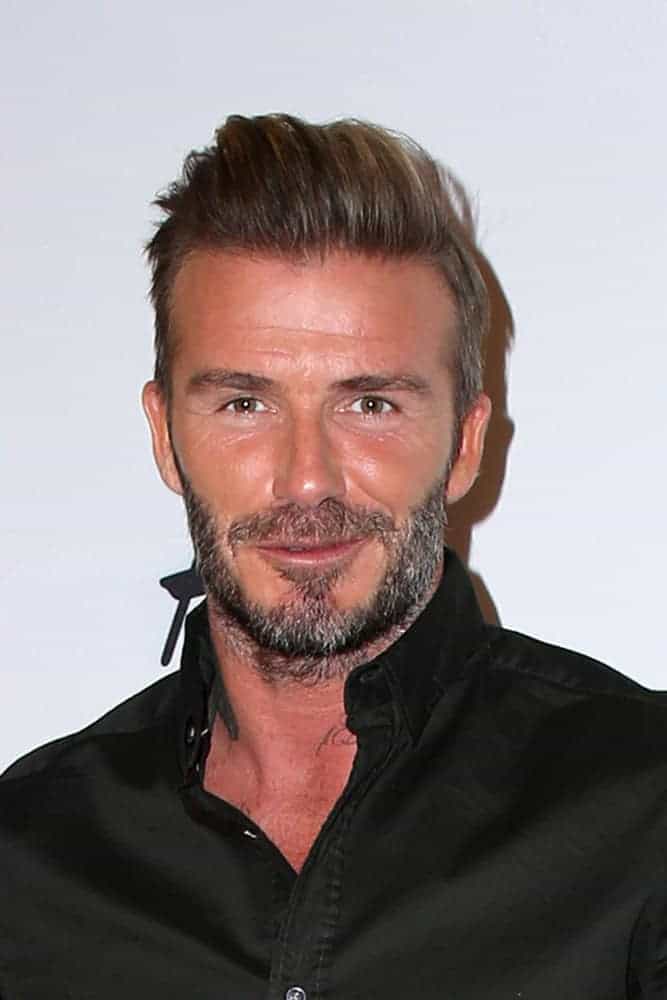 David Beckham looked neat and classy with a pompadour hairstyle that's slicked back at the H&M Modern Essentials Campaign Launch at the H&M Store on September 26, 2016 in Los Angeles, CA.