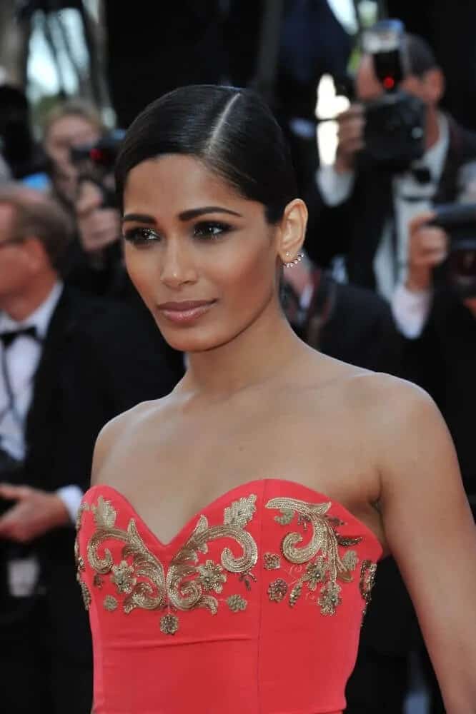 The actress paired her bright and elegant gown with this neat and slick side-parted updo at the gala premiere of "The Homesman" at the 67th Festival de Cannes, May 18, 2014.