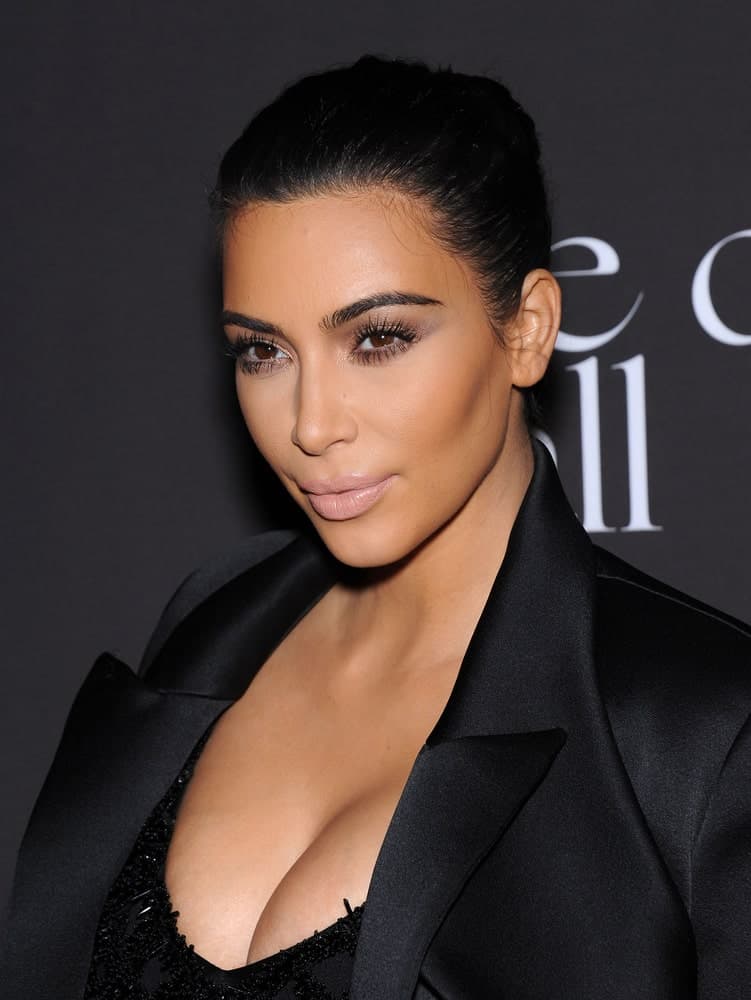 Kim Kardashian arranged her raven hair into a neat bun that perfectly matched her black outfit during The First Annual Diamond Ball on December 11, 2014, in Beverly Hills, CA.