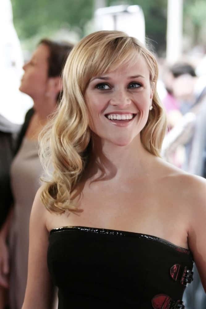 Reese Witherspoon's black strapless dress paired quite perfectly with her long side-swept blond hairstyle with elegant curls and short bangs at the RENDITION World Premiere in Roy Thomson Hall, Toronto, Canada, ON on September 07, 2007.