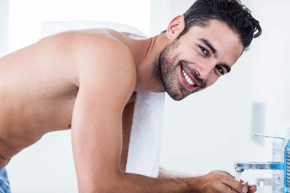 Man washing his beard.