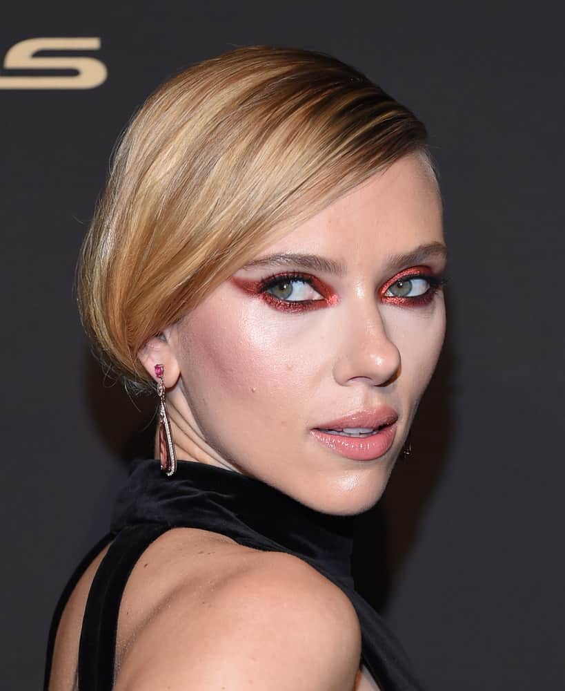 Scarlett Johansson attended the ELLE Women in Hollywood on October 14, 2019 in Westwood, CA. She stunned everyone with her black dress, smoky eyes and elegant low bun hairstyle with long side-swept bangs.