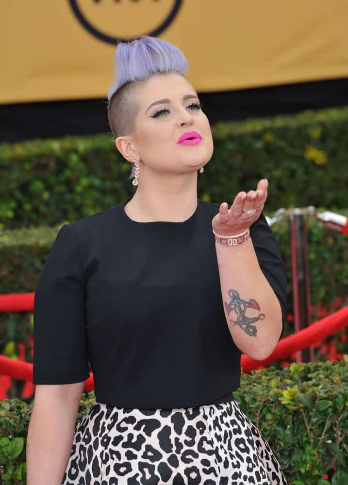 Kelly Osbourne rocking a purple mohawk hairstyle, yet still looking gorgeous while blowing kisses to the media and to her fans at the 2015 Screen Actors Guild Awards on January 25, 2015 in Los Angeles, California.