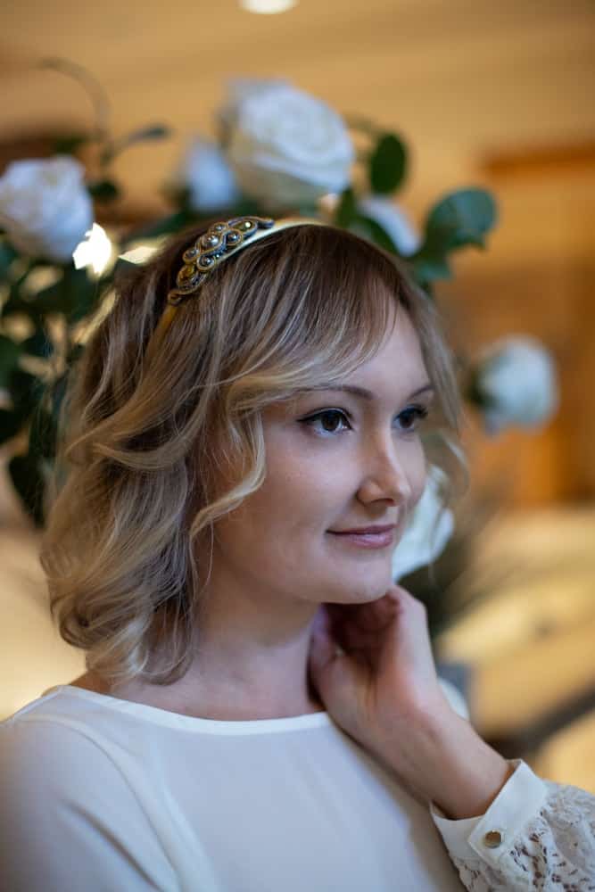 A woman wearing an ornate metal headband.