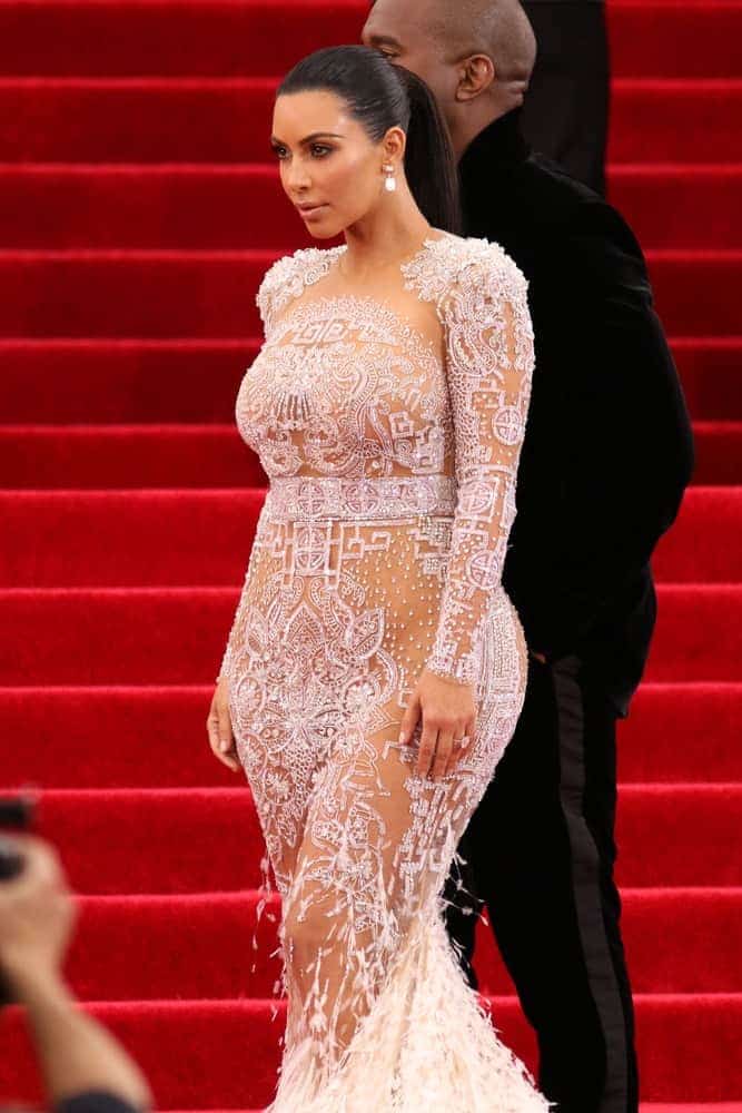 Kim Kardashian dares to bare in a white sheer embellished gown and pulled her dark locks back into a firmed ponytail, proving once again just how fierce and confident she truly is while attending the Costume Institute benefit gala.