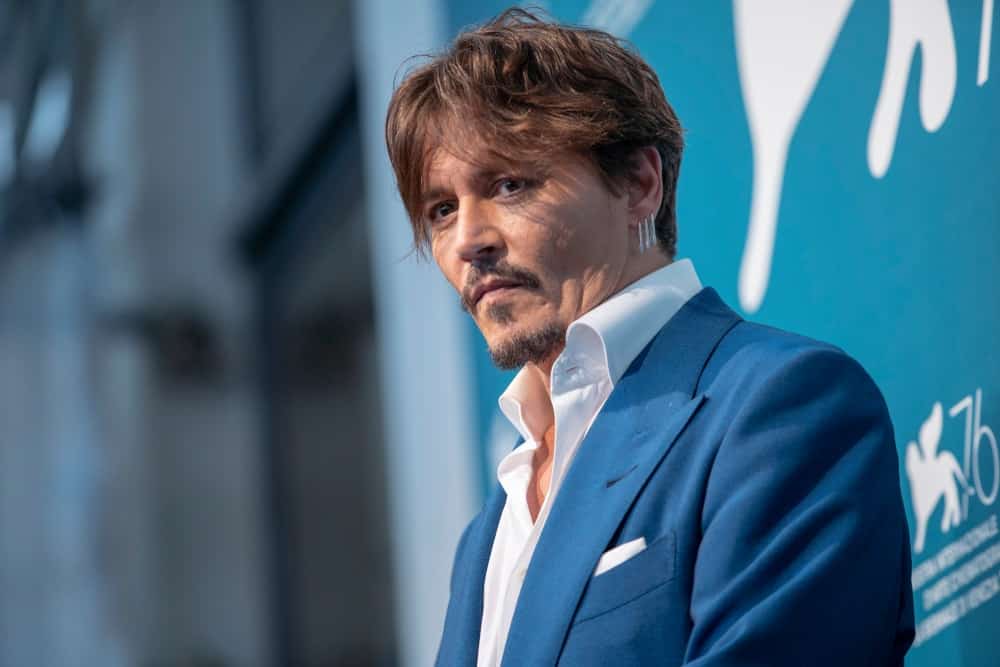 Johnny Depp attended the photocall for the film ''Waiting for the Barbarians'' presented in the 76th Venice Film Festival at Venice Lido last September 6, 2019. He wore a simple blue suit with his tousled reddish brown hair.