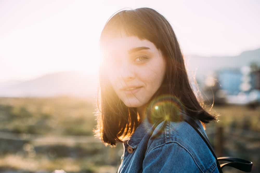 A woman with short layered bangs.