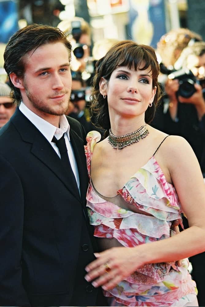 Sandra Bullock and Ryan Gosling attended the 'Murder by numbers' Premiere at the Grand Theatre Lumiere during the 55th Cannes film festival on May 24, 2002 in Cannes, France. Gosling had a side-parted dyed black hairstyle to go with his black suit.