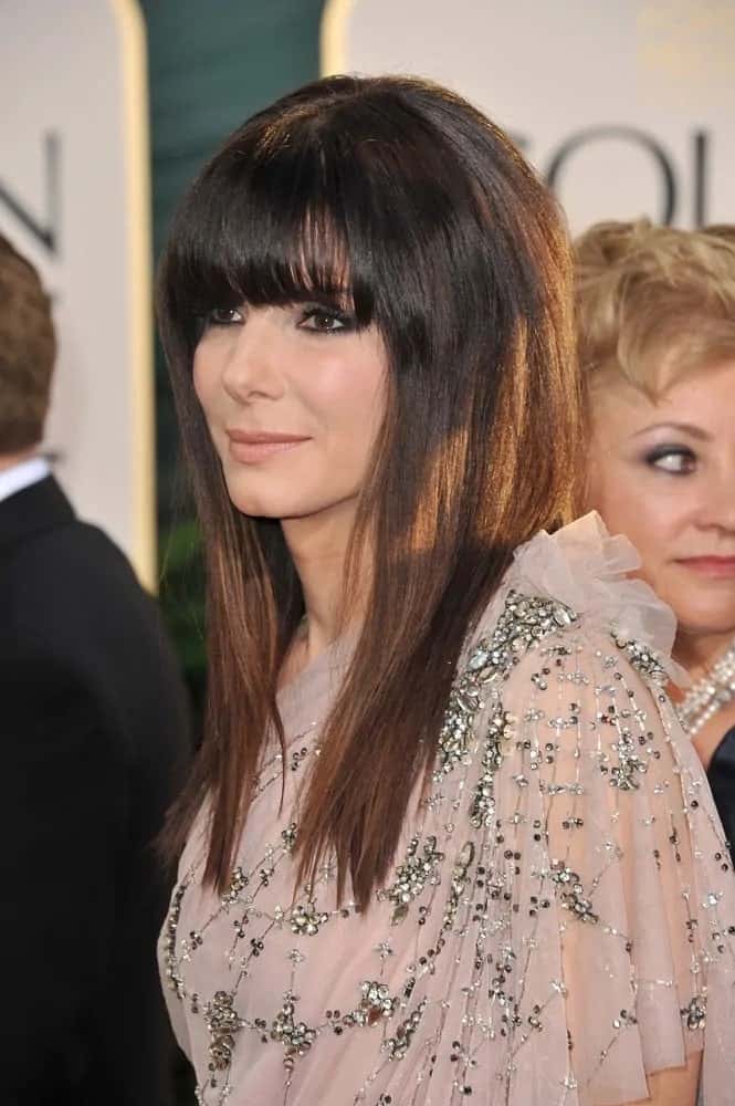 Sandra Bullock was at the 68th Annual Golden Globe Awards back in January 16, 2011. She wore a lovely sheer dress with her straight and layered hair complemented by blunt bangs.