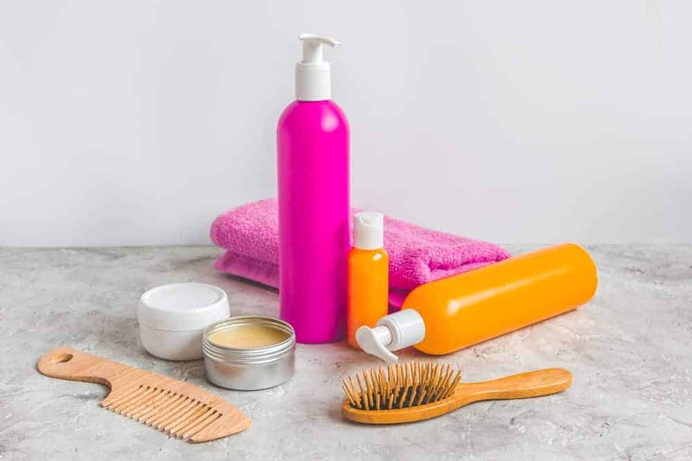 Various types of hair products over a marble table.