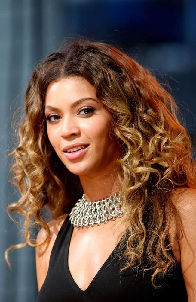 Beyonce on stage for ABC Good Morning America Concert with Beyonce at Times Square, New York, NY on September 8, 2006. She went for a voluminous curly hairstyle paired with a black dress and a statement collar necklace.