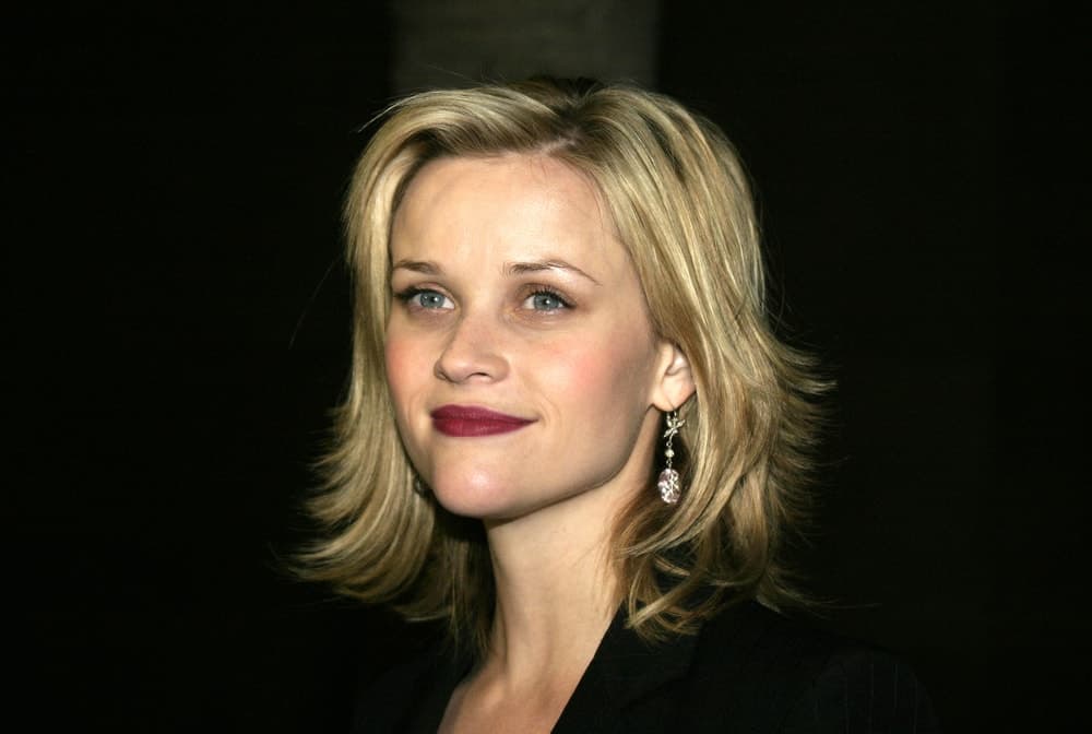 Reese Witherspoon was at the American Cinematheque held at the Egyptian Lloyd E. Rigler Theatre in Hollywood, USA on December 3, 2004. She wore a black outfit with her red lips and tousled blond layered shoulder-length hairstyle.