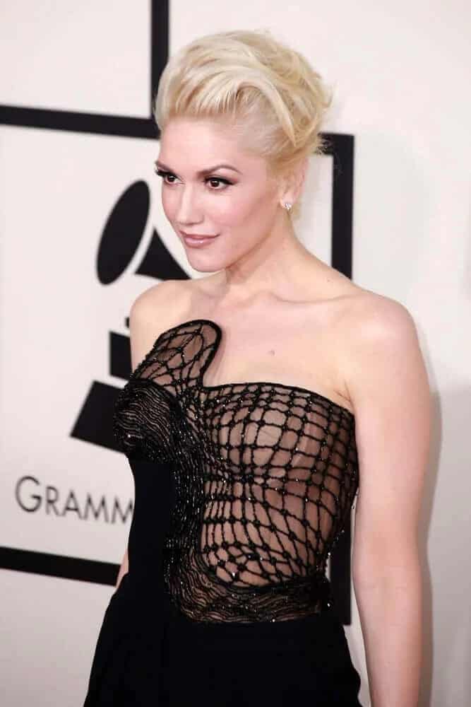 Gwen Stefani's platinum blond hair was styled into an elegant tousled upstyle during the Grammy Awards 2015 on February 8, 2015 in Los Angeles, CA.