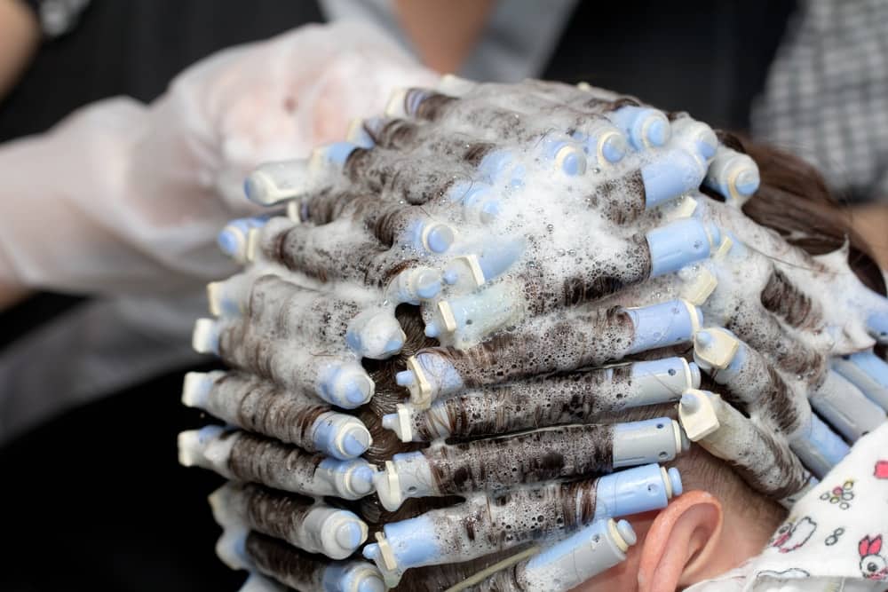 A close look at a woman having a perm.