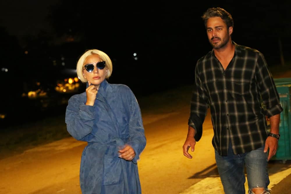 Lady Gaga and Taylor Kinney were seen walking the streets after dinner at a restaurant on July 4, 2015 in Belgrade, Serbia. Lady Gaga was wearing a blue velvet trench coat that she paired with cool sunglasses and a short tousled blond bob hairstyle.