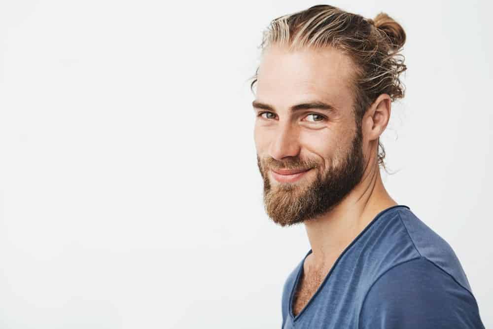 Man with a full beard and a man bun.