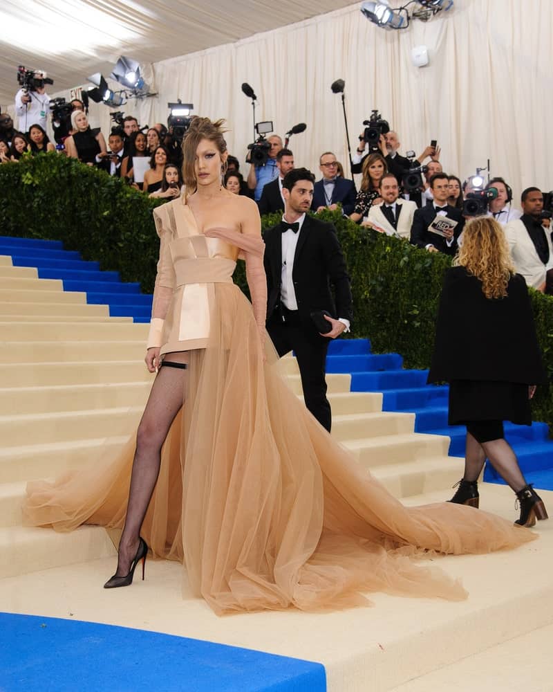 Gigi Hadid attended the 2017 Metropolitan Museum of Art Costume Institute Gala at the Metropolitan Museum of Art in New York on May 1st, 2017. She wore an elaborate gown with her messy bun hairstyle with side-swept bangs.