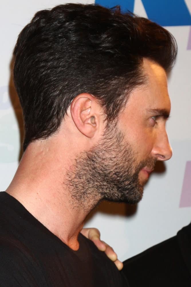 A side view of Adam Levine featuring how his pompadour fade hairstyle integrates with his trimmed beard when he attended the 2013 Wango Tango concert produced by KIIS-FM on May 11, 2013 in Carson, CA.