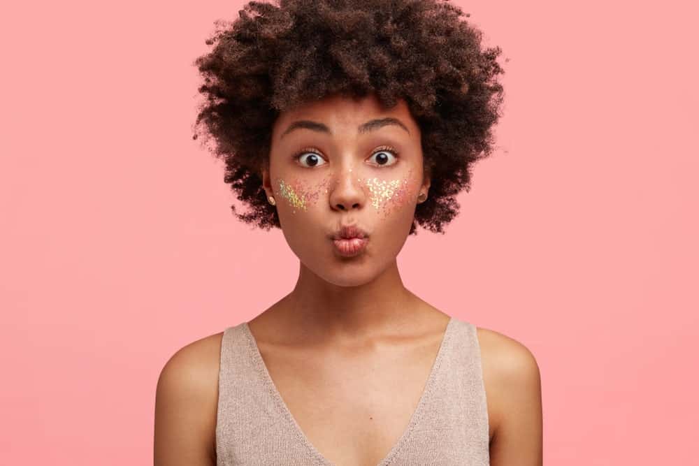 A woman with short curly hair.