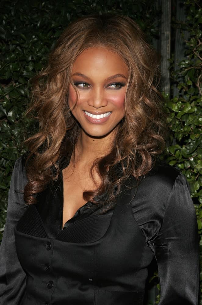 Tyra Banks' caramel-toned hairstyle was long and curly that complements her black satin blouse at the Los Angeles premiere of 'The Producers' held at the Westfield Century City in Century City on December 12, 2005.