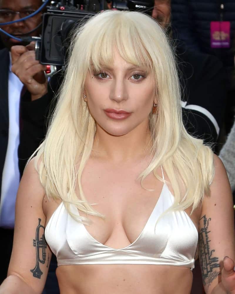 Lady Gaga attended the Billboard's 10th Annual Women in Music event at Cipriani on December 11, 2015 in New York City. She was simple and pretty in her two-piece white silk outfit that complements her loose and layered straight white blond hairstyle with bangs.