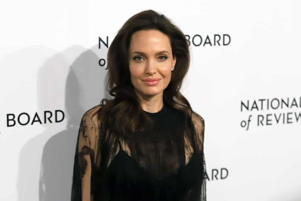 Angelina Jolie attended the National Board of Review Awards at Cipriani on January 9, 2018, in New York. She wore a black sheer dress that she matched with her loose and tousled brunette hairstyle with slight waves at the tips.