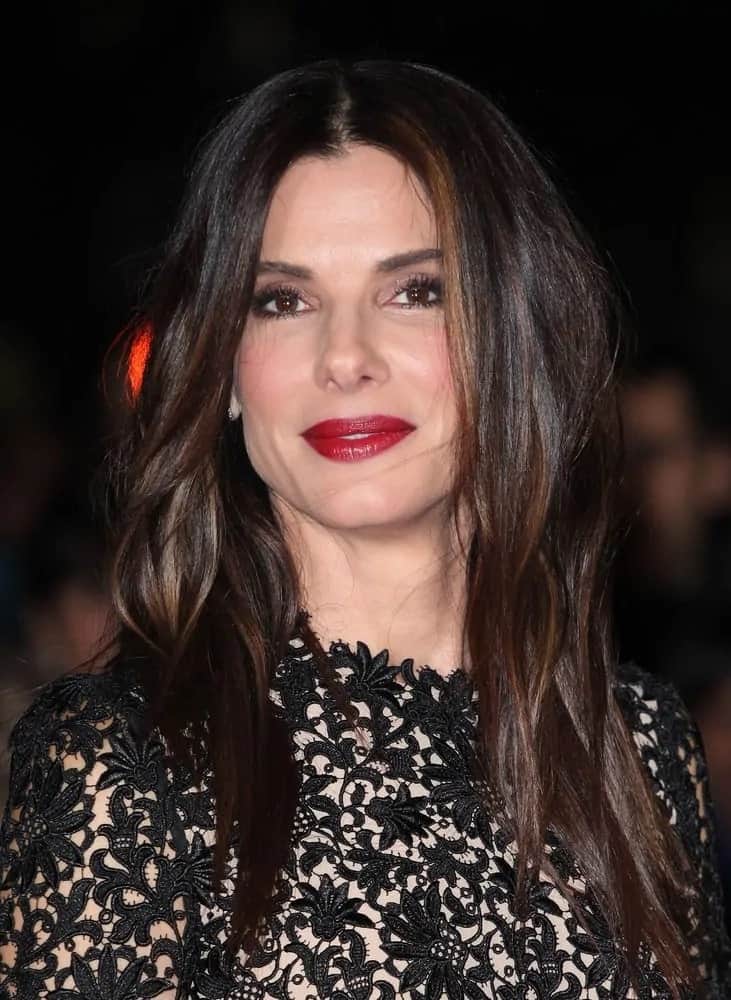 Sandra Bullock had long and straight layers with a side part hairstyle that complemented her white dress at the 'Gravity' premiere last October 1, 2013.