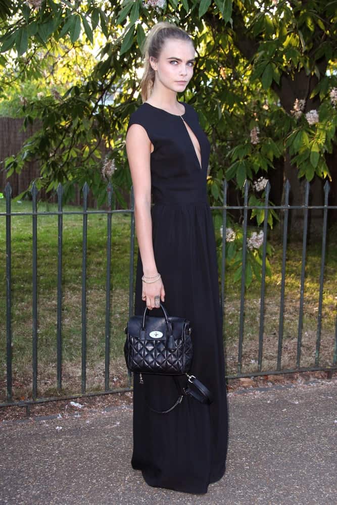 Cara Delevingne went with a simple yet charming high ponytail with highlights to match her simple long black dress when she attended the annual Serpentine Galley Summer Party at The Serpentine Gallery on July 1, 2014 in London, England.