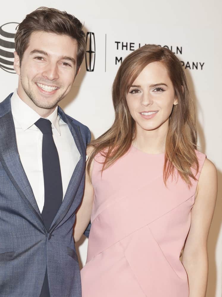 On April 20, 2014, Roberto Aguire and Emma Watson attended the premiere of "Boulevard" during the 2014 Tribeca Film Festival at BMCC Tribeca PAC. Watson wore a simple pink dress with her loose and tousled medium-length hair with highlights and side-swept bangs.