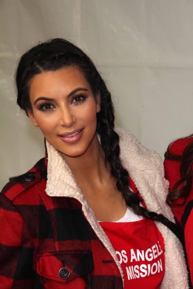 Kim Kardashian with her long jet black locks arranged into a fishtail braid at the LA Mission Thanksgiving Meal Service held on November 23, 2011.