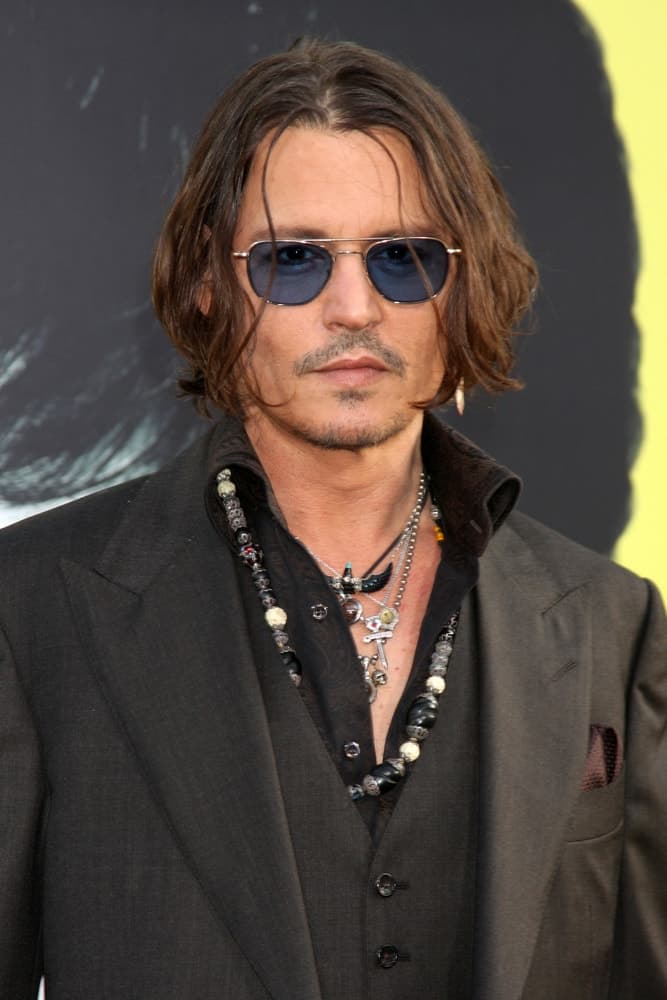 Johnny Depp opted for a long and wavy bob hairstyle with highlights at the "Dark Shadows" - Los Angeles Premiere at Graumans Chinese Theater on May 7, 2012 in Los Angeles.