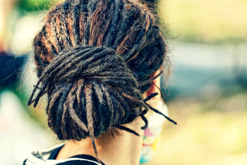 Back view of a person with dreadlocks.