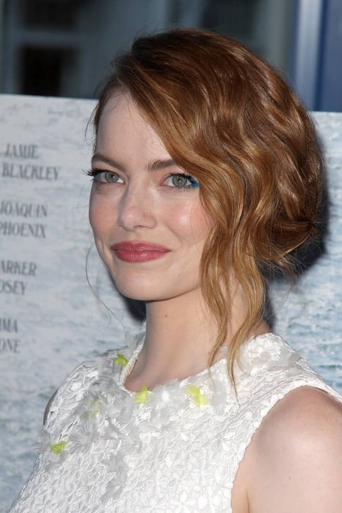 Emma Stone emphasized her gorgeous green eyes with her white floral dress and messy half-up hairstyle that has a slight side-swept finish at the "Irrational Man" Los Angeles Premiere at the Writer's Guild of America Theater on July 9, 2015 in Beverly Hills, CA.