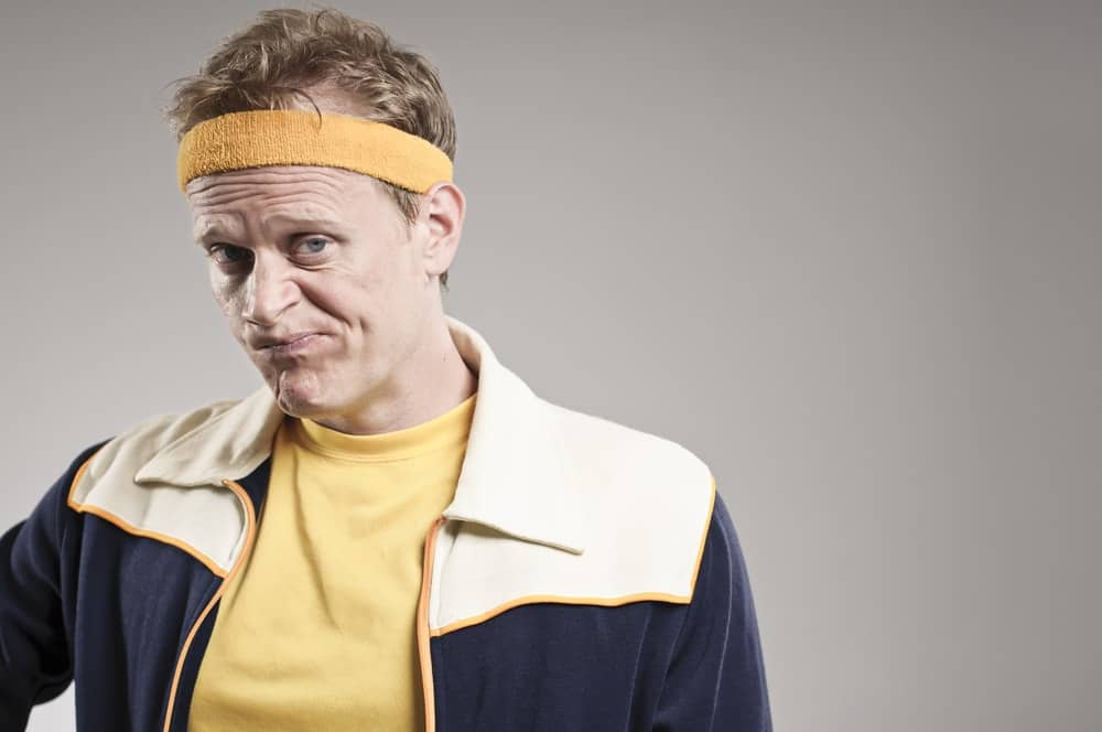 A close look at a man wearing a yellow soft headband.