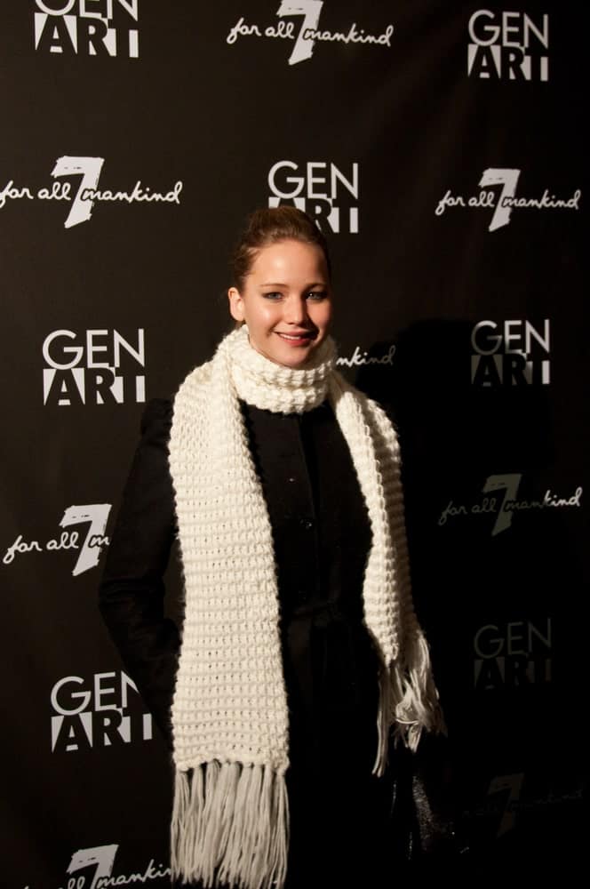 Actress Jennifer Lawrence wore a large white scarf on her black winter outfit when she attended the GenArt 7 Fresh Faces in Film at the Sky Lodge on January 22, 2010 in Park City, Utah. She paired this with a simple brunette ponytail hairstyle and bright smile.