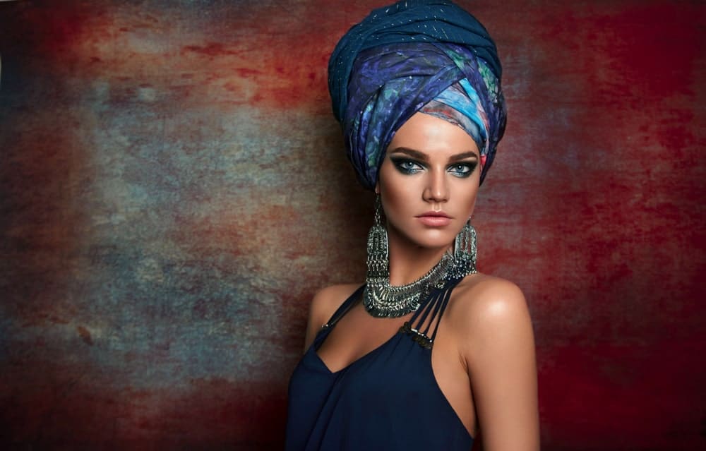 Woman on a rustic background wearing a turban.