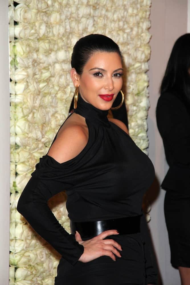 Kim Kardashian emphasized her gold hoop earrings with a neat slicked bun during the QVC Red Carpet Style Event at Four Seasons Hotel, Los Angeles on February 23, 2012.