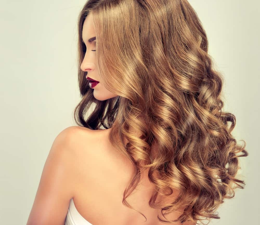 A woman sporting a long and loose perm seen from behind.