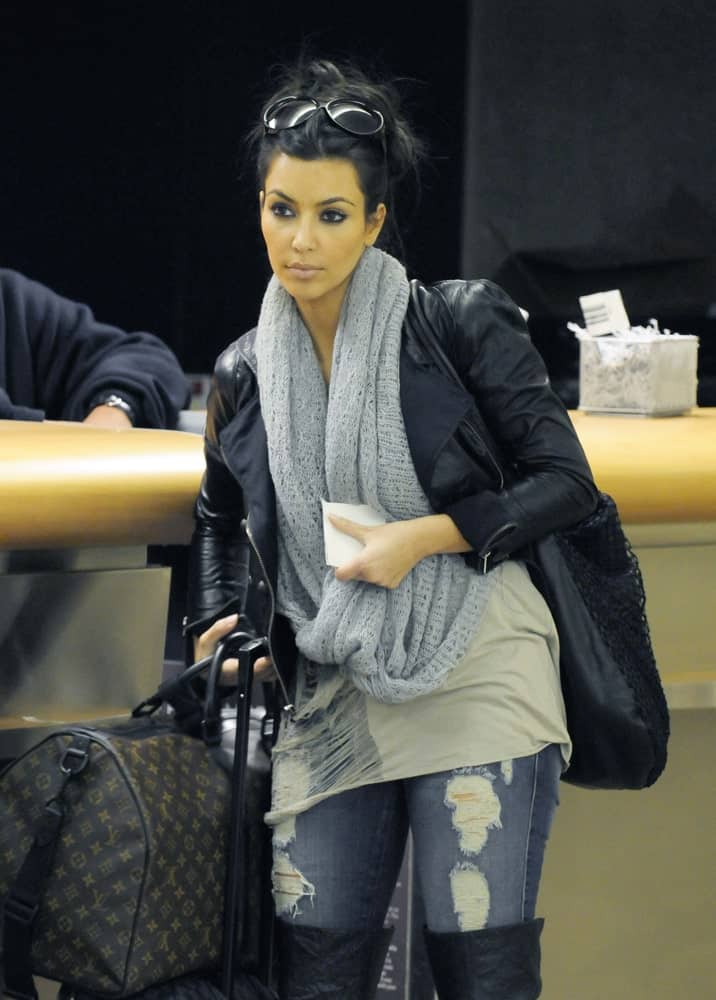 Model and socialite Kim Kardashian was spotted with her luggage at LAX on February 21, 2010. She's wearing a casual outfit along with a messy upstyle that's incorporated with black shades.