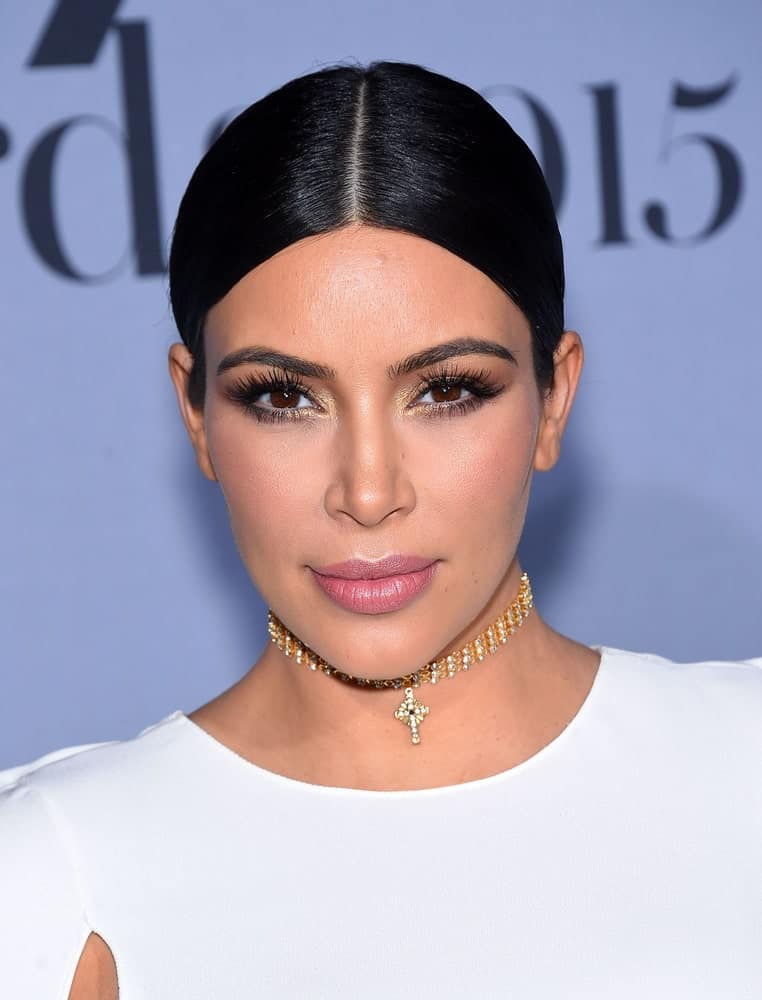 Kim Kardashian in the same slick hairstyle but with a white dress during the InStyle Awards 2015 on October 26, 2015 in Hollywood, CA.