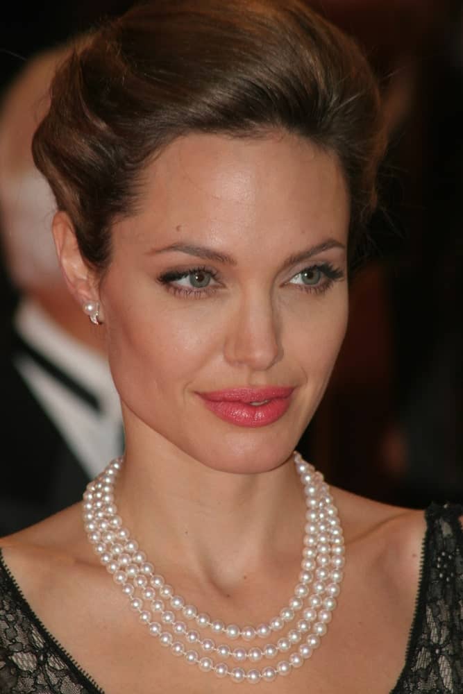 Angelina Jolie attended the premiere of 'The Assassination of Jesse James by the coward Robert Ford' at the 64th Venice Film Festival on September 2, 2007 in Venice. She wore a lovely black dress with her pearl necklace and tousled upstyle hair.