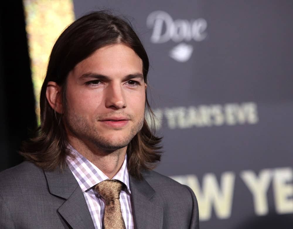 Ashton Kutcher was classy and edgy in his suit and long center-parted hairstyle at the "New Year's Eve" World Premiere on December 5, 2011, in Hollywood, CA.