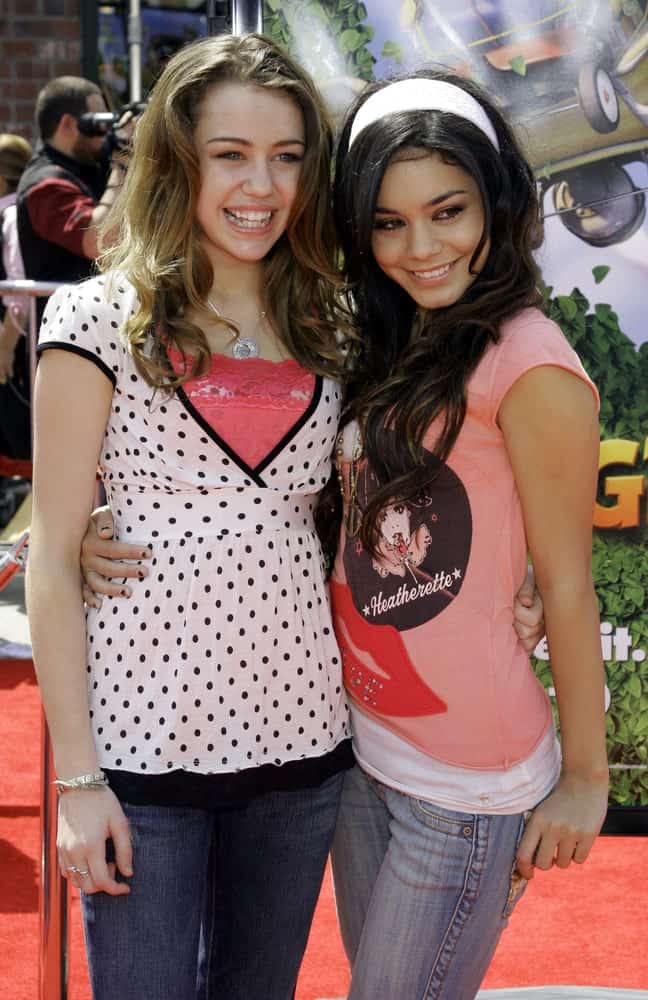 A young Miley Cyrus and Vanessa Hudgens were at the Los Angeles premiere of 'Over The Hedge' held at the Mann Village Theatre in Westwood on April 30, 2006. Cyrus wore a simple casual outfit with her wavy highlighted dark brown hair.