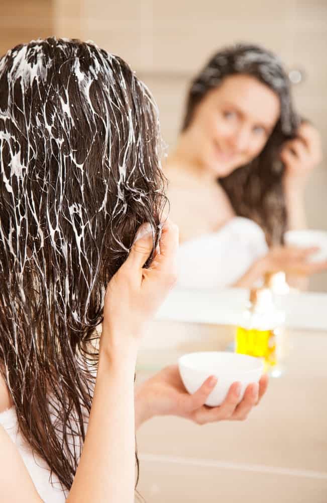 Woman applying hair mask