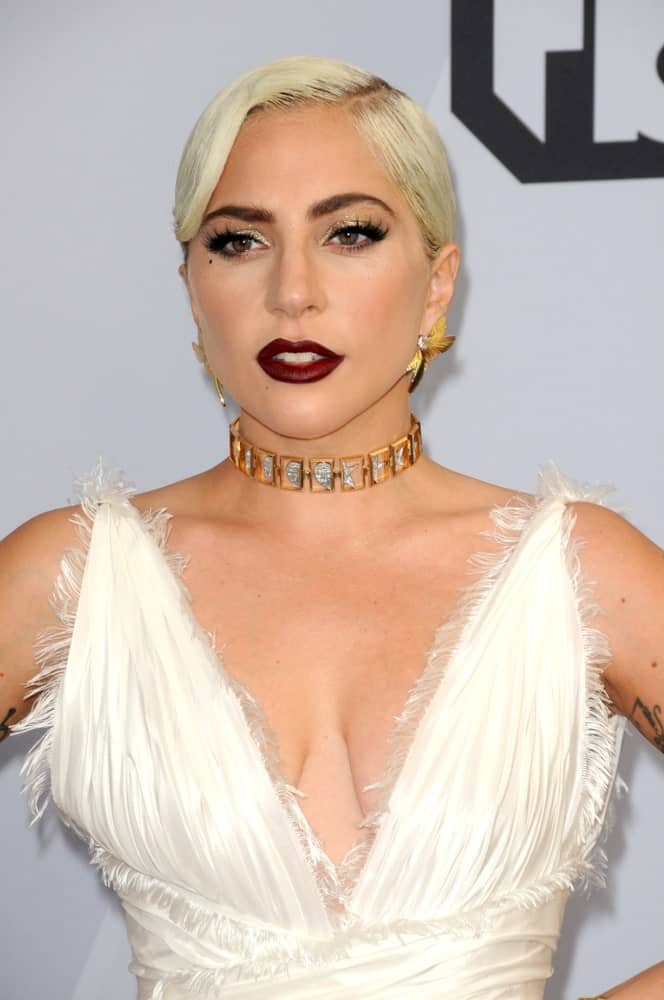 Lady Gagapaired her beautiful white dress and bold red lips with a white blond hairstyle slicked into a low bun at the 25th Annual Screen Actors Guild Awards at the Shrine Auditorium on January 27, 2019 in Los Angeles, CA.