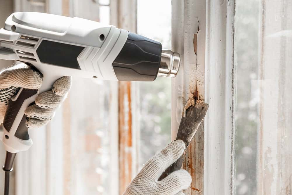 Heat Gun Vs Hair Dryer. A white heat gun being used to melt paint.