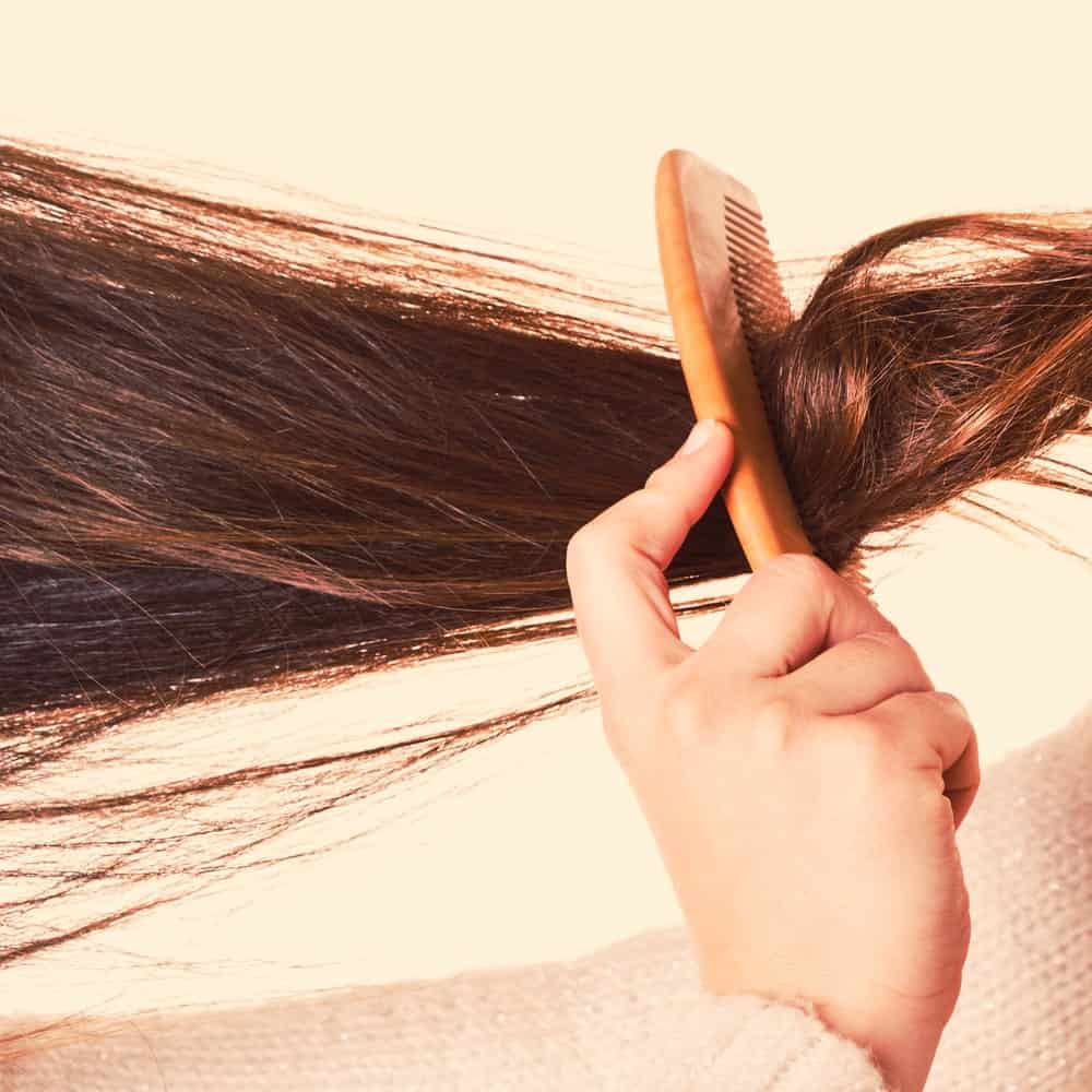 Combing tangled strands of hair.