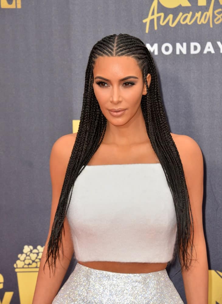 Kim Kardashian styled her long black locks with Fulani braid during the 2018 MTV Movie & TV Awards at the Barker Hanger, Santa Monica Airport last June 16th.