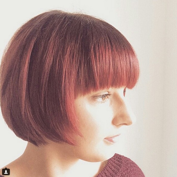 cute short red bob haircut with blunt bangs